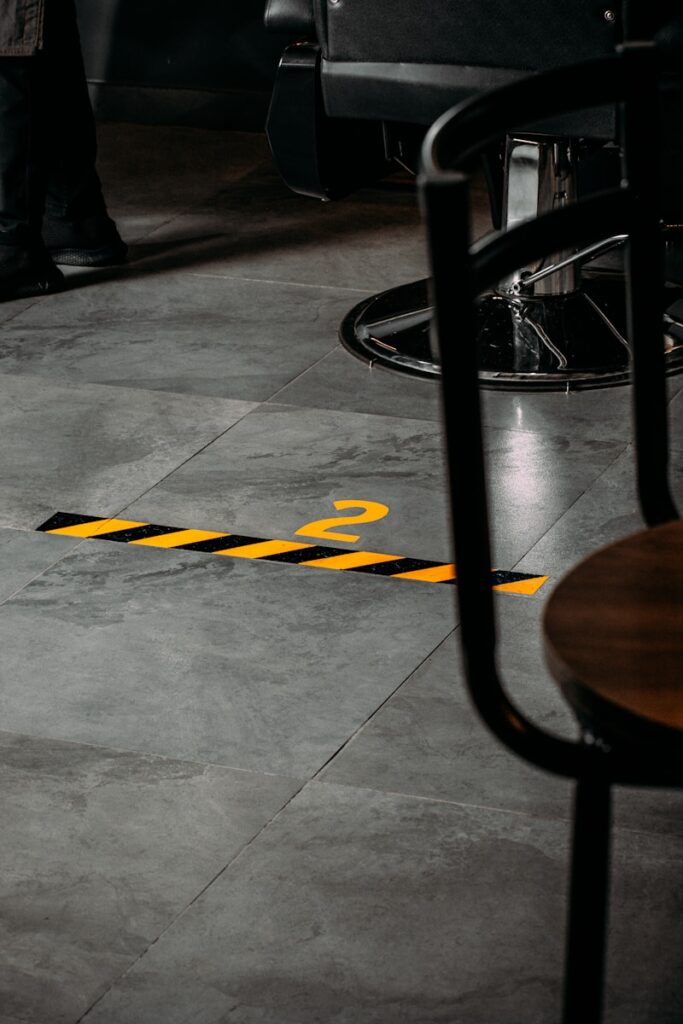 Photo by Amr Tahaâ„¢ a yellow caution line on the floor of a restaurant